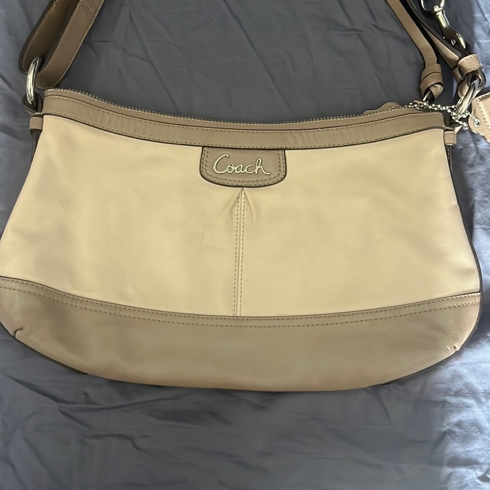 Tan coach shoulder bag.
